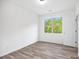 Bright bedroom features wood-look floors and a view of the lush green trees outside at 881 Springs Crest Dr, Dallas, GA 30157