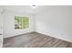Bedroom featuring wood-look floors and a window overlooking trees at 881 Springs Crest Dr, Dallas, GA 30157