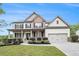 Beautiful two-story home features a landscaped yard, covered front porch, and two car garage at 881 Springs Crest Dr, Dallas, GA 30157