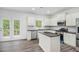 Modern kitchen features stainless steel appliances, an island, and access to the outdoor deck at 881 Springs Crest Dr, Dallas, GA 30157