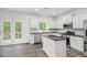 Modern kitchen with stainless steel appliances, granite countertops, island, and access to outdoor deck at 881 Springs Crest Dr, Dallas, GA 30157