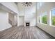 Bright, open living space with fireplace, hardwood floors, and expansive windows with backyard view at 881 Springs Crest Dr, Dallas, GA 30157