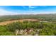 A high angle view shows a residential neighborhood in a wooded area, with a construction site in the background at 900 Fox Croft Pl, Canton, GA 30114