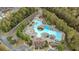 A high angle view shows the multiple pools, waterslide, buildings, and seating at the community pool at 900 Fox Croft Pl, Canton, GA 30114