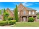 Charming brick two-story home with manicured lawn and mature landscaping at 900 Fox Croft Pl, Canton, GA 30114