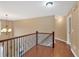Upstairs hallway with dark wood floors and decorative iron railing at 900 Fox Croft Pl, Canton, GA 30114