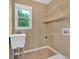 This laundry room features a utility sink and overhead storage space at 900 Fox Croft Pl, Canton, GA 30114