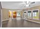Open-concept living room with hardwood floors and access to the kitchen and sunroom at 900 Fox Croft Pl, Canton, GA 30114