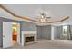 Spacious main bedroom with tray ceiling, fireplace, and ensuite bathroom at 900 Fox Croft Pl, Canton, GA 30114