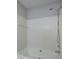 Close-up of white tiled bathtub with a shower head and shelf in bathroom at 2528 Mulberry Rock Rd, Dallas, GA 30157