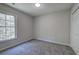 Bedroom with carpet, a closet, and a window with a wooded view at 2528 Mulberry Rock Rd, Dallas, GA 30157