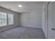 This bedroom has carpet, a double door closet, and a large window at 2528 Mulberry Rock Rd, Dallas, GA 30157
