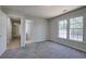 This bedroom has carpet, a large window, and entrances to other rooms at 2528 Mulberry Rock Rd, Dallas, GA 30157