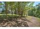 Home exterior featuring a driveway with natural surroundings and carport access at 2528 Mulberry Rock Rd, Dallas, GA 30157