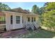 Inviting home featuring a covered front porch, light-colored siding, and mature trees at 2528 Mulberry Rock Rd, Dallas, GA 30157