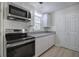 Well-lit kitchen with stainless steel appliances, stylish countertops, and ample cabinet space at 2528 Mulberry Rock Rd, Dallas, GA 30157