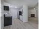 Open concept kitchen with modern appliances, white cabinetry, and connection to the living area at 2528 Mulberry Rock Rd, Dallas, GA 30157