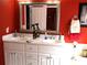 Bright bathroom features double sinks, a large mirror, and vibrant red walls at 28 County Line #2 Rd, Rydal, GA 30171