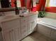 Bathroom featuring a soaking tub, custom window treatment, and a white vanity at 28 County Line #2 Rd, Rydal, GA 30171