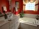 Bathroom featuring a soaking tub, custom window treatment, and a white vanity at 28 County Line #2 Rd, Rydal, GA 30171