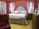 Charming bedroom featuring a tufted headboard, beautiful decor, and a light pink color scheme at 28 County Line #2 Rd, Rydal, GA 30171