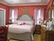Charming bedroom featuring a tufted headboard, beautiful decor, and a light pink color scheme at 28 County Line #2 Rd, Rydal, GA 30171