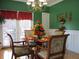 Elegant dining area featuring a chandelier, a round glass-top table, and bright light from a window at 28 County Line #2 Rd, Rydal, GA 30171