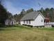 Exterior of a home with a large backyard, shed and deck at 28 County Line #2 Rd, Rydal, GA 30171