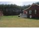 Exterior of the home with a spacious lawn and large deck at 28 County Line #2 Rd, Rydal, GA 30171