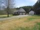 Charming home featuring a two-car garage, a detached garage and a well-maintained front yard at 28 County Line #2 Rd, Rydal, GA 30171