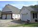 Spacious multi-car garages on a large property, with white garage and landscaping at 28 County Line #2 Rd, Rydal, GA 30171