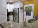 Contemporary kitchen showcasing stainless steel refrigerator, granite counters, and a stylish backyard door at 28 County Line #2 Rd, Rydal, GA 30171