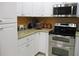 This modern kitchen boasts stainless steel appliances, granite counters, and plenty of storage space at 28 County Line #2 Rd, Rydal, GA 30171