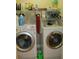 Laundry room with front loading washer and dryer, storage shelves above at 28 County Line #2 Rd, Rydal, GA 30171