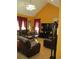 Comfortable living room with vaulted ceilings, a ceiling fan, a flat screen tv, and leather furniture at 28 County Line #2 Rd, Rydal, GA 30171