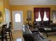 Inviting living room with leather seating, wood floors, and natural light through a door and windows at 28 County Line #2 Rd, Rydal, GA 30171