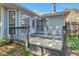 Enclosed back deck with wooden railing features a door leading into the house at 814 Arbor Hill Dr, Stone Mountain, GA 30088