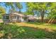 Large backyard features lush green grass, mature trees, and a wooden privacy fence at 814 Arbor Hill Dr, Stone Mountain, GA 30088