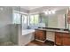 Bathroom featuring a glass-enclosed shower, soaking tub, double sink vanity, and natural light at 814 Arbor Hill Dr, Stone Mountain, GA 30088