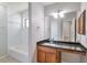 Well-lit bathroom featuring a granite countertop and a shower-tub combo at 814 Arbor Hill Dr, Stone Mountain, GA 30088