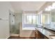 Updated bathroom boasts a glass shower, soaking tub, and a sleek double vanity at 814 Arbor Hill Dr, Stone Mountain, GA 30088