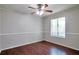 Bedroom featuring hardwood floors, a ceiling fan, and ample natural light from the window at 814 Arbor Hill Dr, Stone Mountain, GA 30088