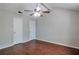 Bedroom featuring hardwood floors, ceiling fan, and two closets, offering ample storage at 814 Arbor Hill Dr, Stone Mountain, GA 30088