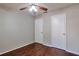Bedroom with hardwood floors, ceiling fan, and access to two closets at 814 Arbor Hill Dr, Stone Mountain, GA 30088