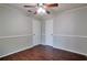 Bedroom featuring hardwood floors, ceiling fan, and two closets for ample storage at 814 Arbor Hill Dr, Stone Mountain, GA 30088