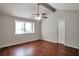 Spacious bedroom featuring hardwood floors, ceiling fan, and a window providing natural light at 814 Arbor Hill Dr, Stone Mountain, GA 30088