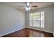 Bright bedroom featuring hardwood floors, ceiling fan, and a large window at 814 Arbor Hill Dr, Stone Mountain, GA 30088