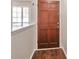 View of the entryway featuring wood flooring, a solid wood door, fresh neutral paint, and natural light at 814 Arbor Hill Dr, Stone Mountain, GA 30088