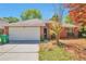 Charming one-story red brick home featuring a two-car garage, lush landscaping, and a well-maintained lawn at 814 Arbor Hill Dr, Stone Mountain, GA 30088