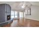 Inviting living room with hardwood floors, modern ceiling fan, and a distinctive painted brick fireplace at 814 Arbor Hill Dr, Stone Mountain, GA 30088